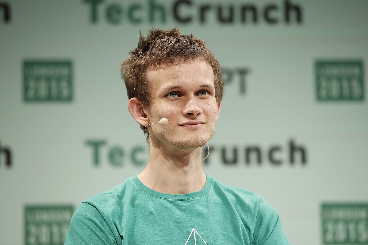 Vitalik Buterin, in a green T-shirt with a headset microphone, sitting in front of a TechCrunch backdrop marked London 2015