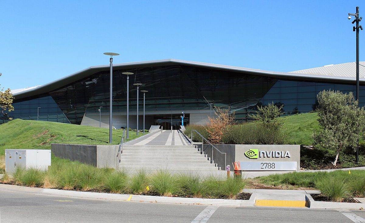 A low glass-and-steel building with a folded, angular roof behind a wide flight of steps, with an Nvidia sign reading 2788 on a wall at the right