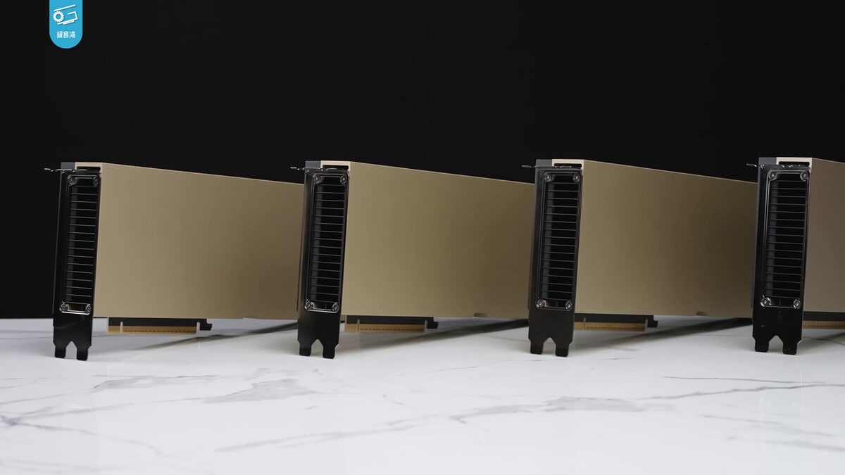 Four gold-colored graphics cards standing in a row on a white marble surface against a black background, their black vented metal brackets facing the camera.